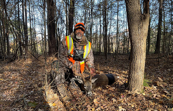 Johnny Center kneeling next to a dead deer Johnny Center kneeling next to a dead deer
