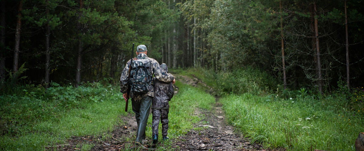 father and son walking in a wooded area father and son walking in a wooded area
