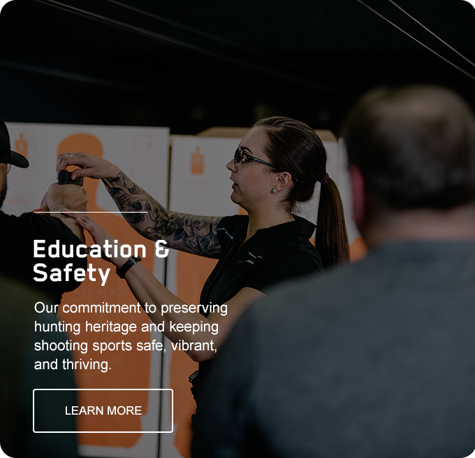 Education & Safety; Out commitment to preserving hunting heritage and keeping shooting sports safe, vibrant, and thriving; Learn More; range educator showing shooter how to hold a handgun