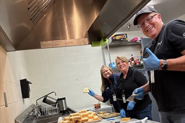 Sales Team (Front to Back: Steve, Leslie and Colista) have fun volunteering at the Boys & Girls Club.
